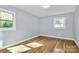 Bedroom with hardwood floors and natural light coming in through two windows at 680 Lakeside Dr, Rock Hill, SC 29730