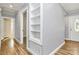 Hallway with hardwood floors, built-in shelving and natural light from front door window at 680 Lakeside Dr, Rock Hill, SC 29730