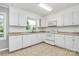 Modern kitchen with white cabinets, updated appliances, and tile flooring at 680 Lakeside Dr, Rock Hill, SC 29730