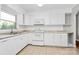 Well-lit kitchen featuring white appliances, ample counter space, and sleek tile floors at 680 Lakeside Dr, Rock Hill, SC 29730