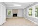 Bright living room features brick fireplace, tile flooring, and outdoor access at 680 Lakeside Dr, Rock Hill, SC 29730