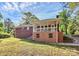 Charming brick home featuring a covered porch, outdoor staircase and well-maintained lawn at 680 Lakeside Dr, Rock Hill, SC 29730
