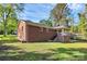 Brick house with covered back porch and grassy yard under blue sky at 680 Lakeside Dr, Rock Hill, SC 29730