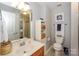 Tidy bathroom featuring a mirror, single sink vanity, toilet, and linen storage at 765 Southwest Dr, Davidson, NC 28036