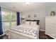 Comfortable bedroom with a white wood bed frame, neutral walls and coordinated decor at 765 Southwest Dr, Davidson, NC 28036