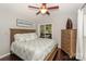 Comfortable bedroom with a ceiling fan, wooden dresser, and access to a screened porch at 765 Southwest Dr, Davidson, NC 28036