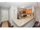 Well-lit kitchen featuring stainless steel appliances, granite countertops, and wood cabinets at 765 Southwest Dr, Davidson, NC 28036