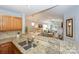 Bright kitchen with granite countertops, stainless steel sink, and open view to the living area at 765 Southwest Dr, Davidson, NC 28036