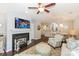 Open-concept living area with hardwood floors, a fireplace, and a partial view of the kitchen at 765 Southwest Dr, Davidson, NC 28036