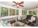 Inviting screened-in porch with comfortable furniture and wooded backyard view at 765 Southwest Dr, Davidson, NC 28036
