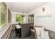 Enclosed porch with comfortable seating, a bar height table and wooded views at 765 Southwest Dr, Davidson, NC 28036