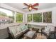 Comfortable screened-in porch with neutral furniture, pillows, and a ceiling fan at 765 Southwest Dr, Davidson, NC 28036