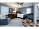Comfortable bedroom featuring neutral colors, a ceiling fan, and ample natural light from the windows at 7820 Elm Tree Ln, Charlotte, NC 28227