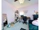 Bright bedroom featuring pink walls, modern desk, comfortable seating area, and contemporary chandelier at 7820 Elm Tree Ln, Charlotte, NC 28227