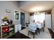 Bright dining area showing natural light, an elegant chandelier, and views of the kitchen at 7820 Elm Tree Ln, Charlotte, NC 28227
