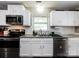 Functional kitchen featuring white cabinets, subway tile backsplash, and stainless steel appliances at 7820 Elm Tree Ln, Charlotte, NC 28227
