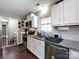 The functional kitchen shows a view of white cabinets and stainless steel appliances at 7820 Elm Tree Ln, Charlotte, NC 28227