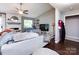 Inviting living room with a ceiling fan, a fireplace, and a large window offering lots of natural light at 7820 Elm Tree Ln, Charlotte, NC 28227