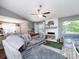 Bright living room featuring vaulted ceilings, a ceiling fan, fireplace, and sliding doors to the outdoors at 7820 Elm Tree Ln, Charlotte, NC 28227
