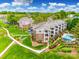 Aerial view of apartment buildings with a pool and lush landscaping at 7822 Village Harbor Dr, Cornelius, NC 28031