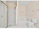 Modern bathroom featuring a glass shower, white tile, a soaking tub, and a toilet, for a serene bathing experience at 7822 Village Harbor Dr, Cornelius, NC 28031