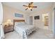 Comfortable bedroom with a ceiling fan, connecting bathroom access, and a nightstand for convenience at 7822 Village Harbor Dr, Cornelius, NC 28031
