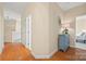 Hallway with hardwood floors, leading to a bedroom and kitchen, showcasing the home's layout at 7822 Village Harbor Dr, Cornelius, NC 28031