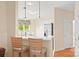 Eat-in kitchen featuring a quartz breakfast bar, stainless steel appliances and bright natural light at 7822 Village Harbor Dr, Cornelius, NC 28031