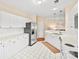 Bright kitchen features stainless steel appliances, white cabinets and tile flooring at 7822 Village Harbor Dr, Cornelius, NC 28031