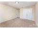 Bright bedroom featuring plush carpet, neutral walls, closet, and a door to another room at 832 Summerlake Dr, Fort Mill, SC 29715