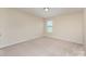 Inviting bedroom with soft carpet, a light-filled window, and calming neutral-colored walls at 832 Summerlake Dr, Fort Mill, SC 29715