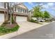 Well-kept townhome featuring a stone facade, a two-car garage, and tidy landscaping at 832 Summerlake Dr, Fort Mill, SC 29715