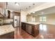 Modern kitchen with stainless appliances, granite counters, and an island, open to the living area at 832 Summerlake Dr, Fort Mill, SC 29715