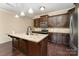 Stylish kitchen featuring a large island, granite countertops, and dark wood cabinetry at 832 Summerlake Dr, Fort Mill, SC 29715