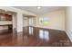 Bright living room with hardwood floors, opening to a dining area with lots of natural light at 832 Summerlake Dr, Fort Mill, SC 29715