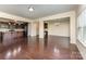 Open-concept living room featuring hardwood floors, kitchen bar, and neutral paint at 832 Summerlake Dr, Fort Mill, SC 29715
