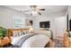 Cozy bedroom showcasing a comfortable bed, ceiling fan, and plenty of natural light at 8322 Summerglen Cir, Charlotte, NC 28227