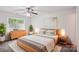 Bright bedroom with a large window, ceiling fan, and stylish furnishings for a comfortable retreat at 8322 Summerglen Cir, Charlotte, NC 28227