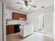 Functional kitchen featuring dark cabinets, island, modern appliances, and access to the outdoors at 8322 Summerglen Cir, Charlotte, NC 28227