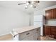 Bright kitchen features an island with light countertop, white refrigerator, and warm wood cabinetry at 8322 Summerglen Cir, Charlotte, NC 28227