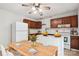 Bright kitchen and dining area featuring wood cabinets, wooden dining table, and modern appliances at 8322 Summerglen Cir, Charlotte, NC 28227