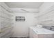 Functional laundry room with washer, dryer, and wire shelving for ample storage space at 8322 Summerglen Cir, Charlotte, NC 28227