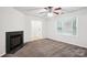 Spacious, well-lit living room with a fireplace, ceiling fan, and a large window, offering a comfortable living space at 8322 Summerglen Cir, Charlotte, NC 28227
