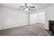 Bright living room features a fireplace, ceiling fan, and open archway to a dining area, enhancing the spacious feel at 8322 Summerglen Cir, Charlotte, NC 28227