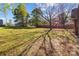 Spacious, partially shaded backyard with lush green grass and mature trees, offering privacy and ample space at 834 Murphy St, Kannapolis, NC 28081