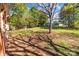 Expansive backyard with lush greenery, mature trees, and partial brick patio, perfect for outdoor enjoyment at 834 Murphy St, Kannapolis, NC 28081