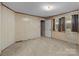 Bedroom with beige walls, carpeting, and a window with curtains at 834 Murphy St, Kannapolis, NC 28081