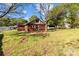 Charming brick home featuring a large grassy yard with mature trees, offering a serene outdoor space at 834 Murphy St, Kannapolis, NC 28081