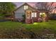 Charming brick home with a cozy front porch, surrounded by blossoming plants and a well-manicured lawn at 834 Murphy St, Kannapolis, NC 28081