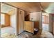 Unfinished room upstairs shows wood paneled walls and floors in need of repair and renovation at 834 Murphy St, Kannapolis, NC 28081
